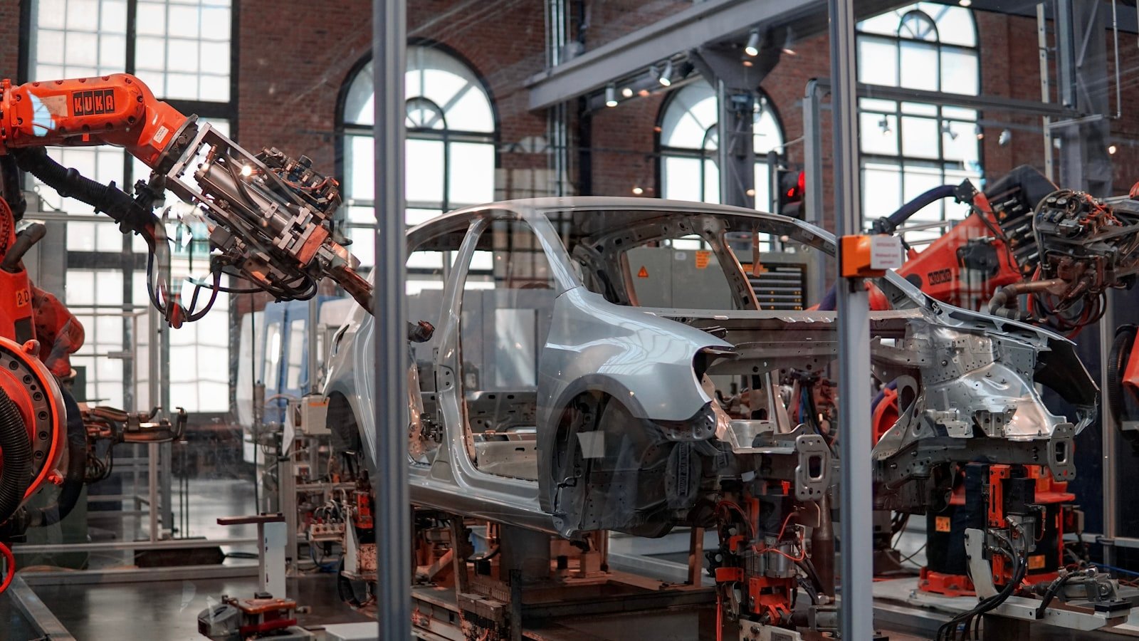 Robotic arms welding a car body on an automotive assembly line